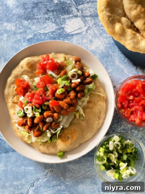 Native American Fry Bread Tacos 14 Indian Tacos in fry bread, white plate, blue background