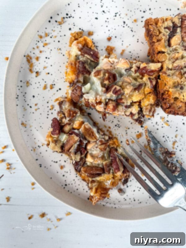 top view of seven layer cookies on plate with fork