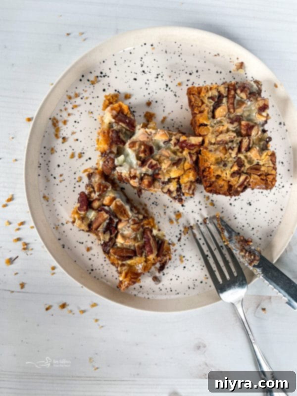 seven layer cookies on speckled plate with knife and fork