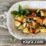 Zucchini & Tomatoes in a white decorative serving plate.