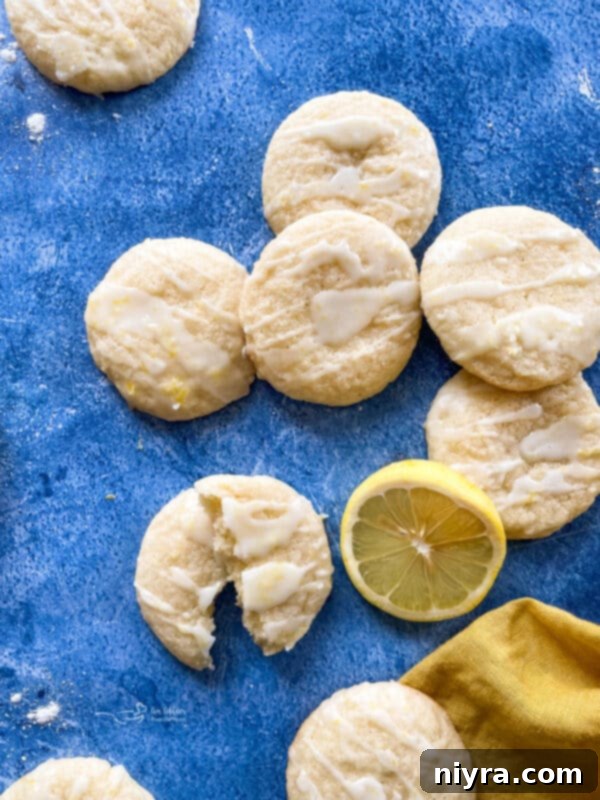 Close-up of freshly baked chewy glazed lemon cookies, highlighting their soft texture and zesty glaze