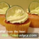Side view of Pina Colada Cupcakes on a white plate