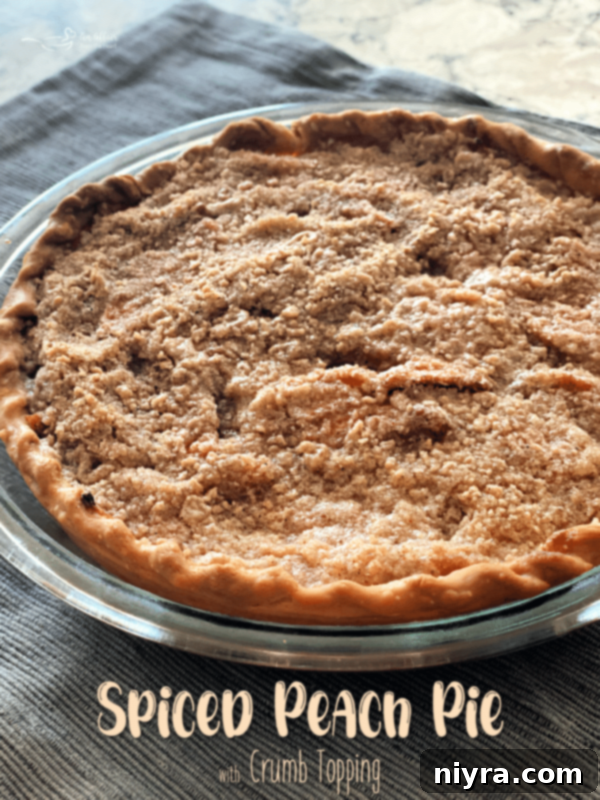 Whole spiced peach pie with crumb topping