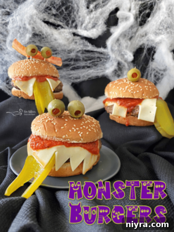 A deliciously spooky Monster Burger, adorned with sharp cheese teeth and a vibrant pickle tongue, ready to be devoured.
