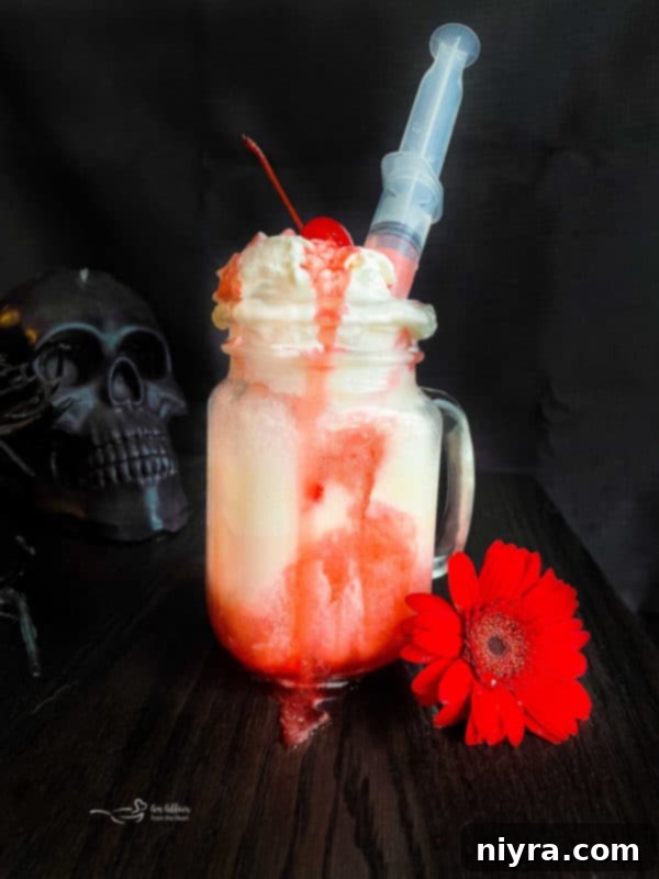 Dirty Shirley's Crimson Cloud 5 Bloody Dirty Shirley Float with a grenadine-filled syringe
