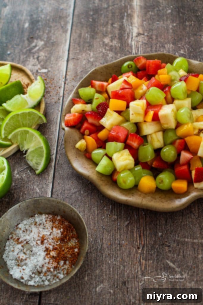 Vibrant Margarita Fruit Salad with various fruits and a lime slice