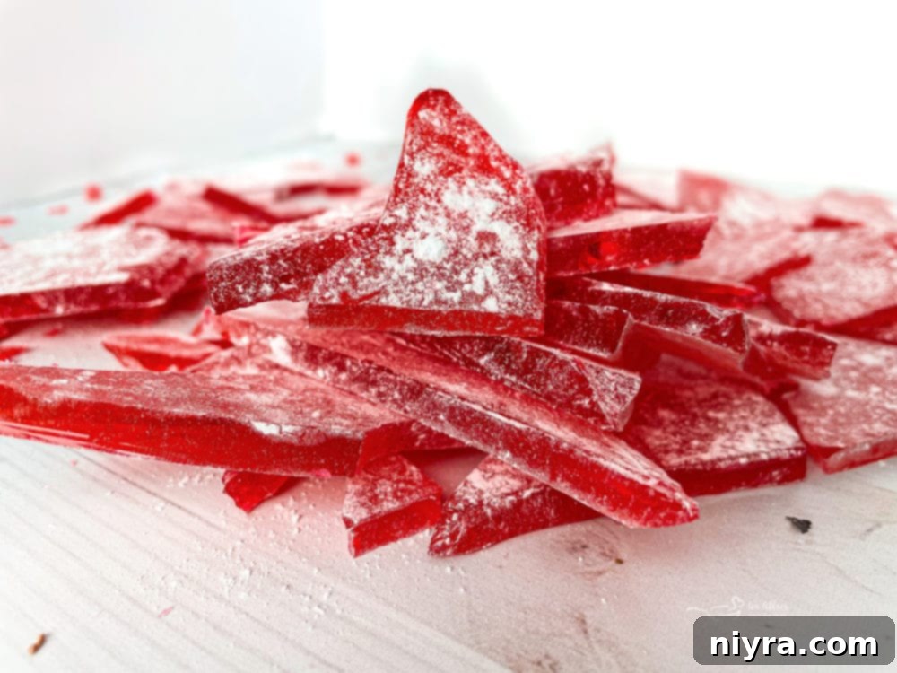 How to Make Cinnamon Rock Candy 14 Broken pieces of cinnamon rock candy on a white surface, artfully arranged