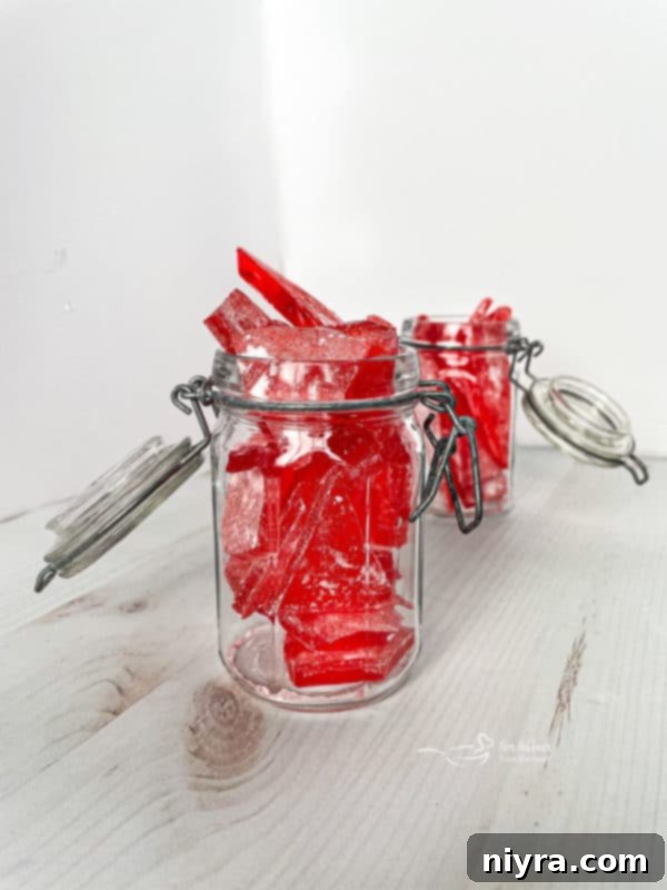 How to Make Cinnamon Rock Candy 16 Two jars filled with cinnamon rock candy, displayed on a wooden surface