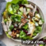 Grilled Chicken Waldorf A Modern Classic 4 One bowl of salad with broccoli, lettuce, chicken, grapes, walnuts, pears, and dressing