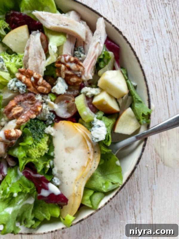 Chicken Waldorf Salad Top view of Waldorf salad in a bowl with walnuts and pears