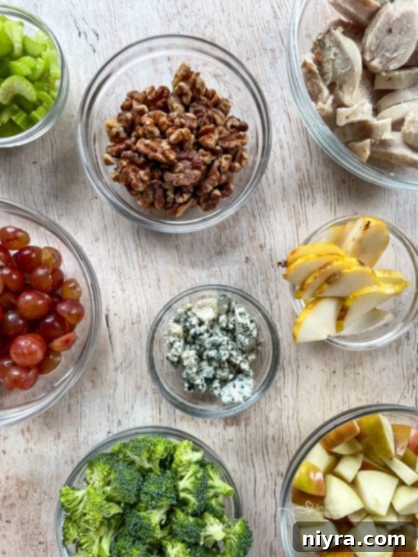 Waldorf Salad Recipe with Chicken Assorted toppings for Waldorf salad: broccoli, blue cheese, grapes, pears, walnuts, celery, apples, chicken