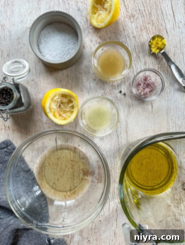 Waldorf Salad from Scratch Vinaigrette ingredients in bowls on a wooden surface with olive oil and citrus