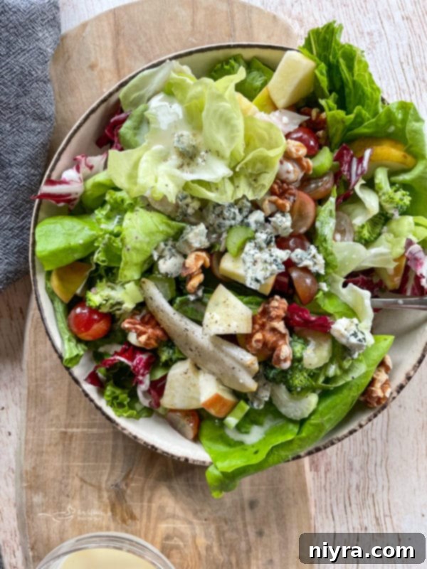 Chicken Waldorf Salad Top view of a bowl with fruit, leafy greens, and chicken