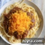 Cincinnati Chili over spaghetti white plate