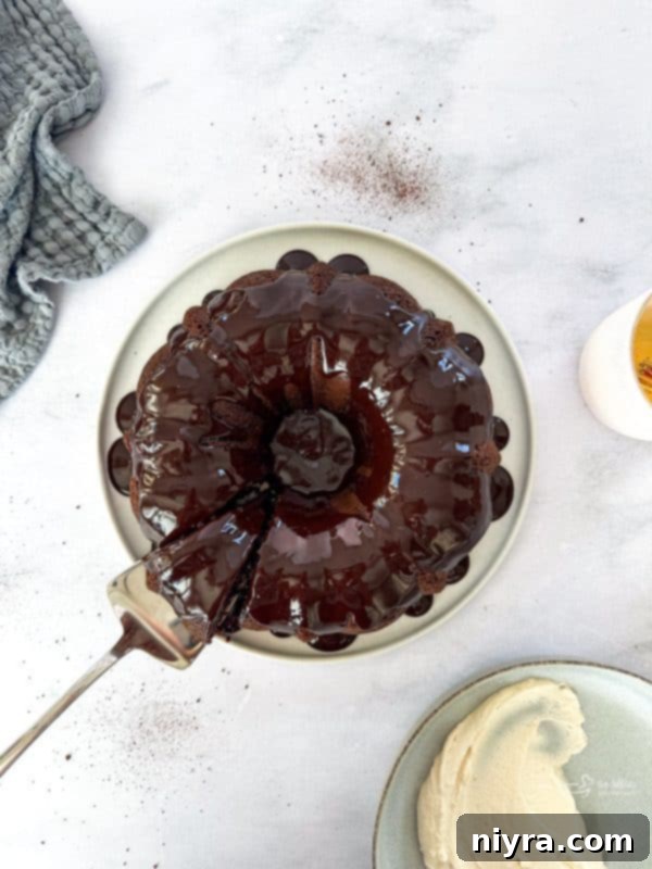 A beautifully presented slice of Chocolate Espresso Bundt Cake on a white plate, ready to be enjoyed.