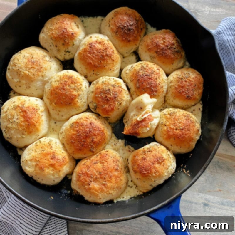 Italian Cheesy Bites 13 Italian Cheese Bombs served in a cast-iron skillet, with marinara and a festive touch.