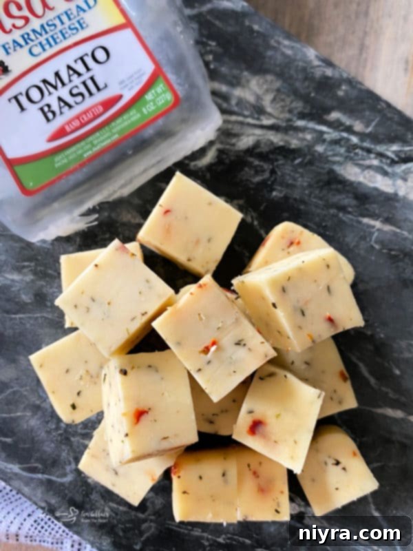 Italian Cheesy Bites 14 Close-up of Jisa Farmstead Cheese block, Tomato Basil flavor.