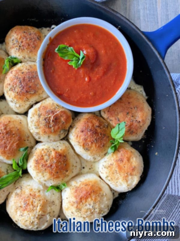 Italian Cheesy Bites 15 A large batch of golden Italian Cheese Bombs cooling on a wire rack.