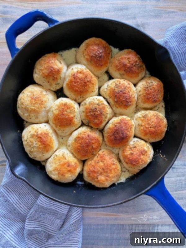 Italian Cheesy Bites 10 Italian Cheese Bombs arranged in a skillet and brushed with garlic butter.