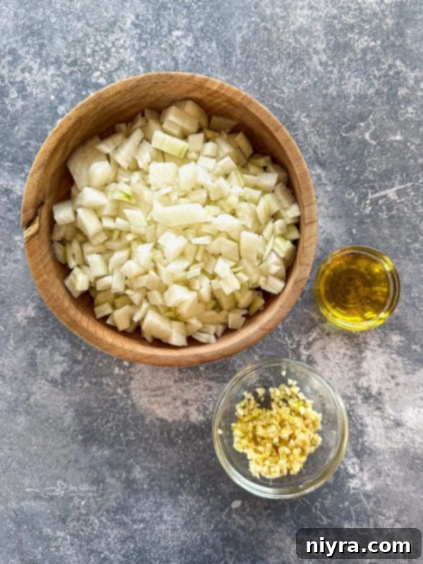 Various ingredients for tomato soup laid out on a table.
