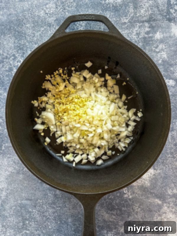 Step one: Sautéing diced onions in olive oil in a large pot.