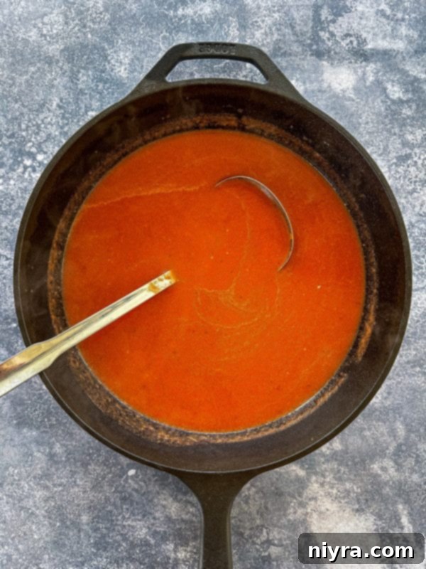 Step three: Pureeing the tomato soup in a blender until smooth.
