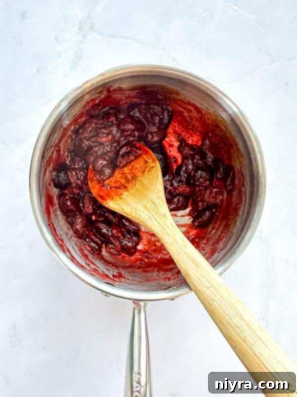Zesty Cherry Limeade Sweet Rolls 10 Sweet cherries simmering in a saucepan with lime zest, creating the filling.