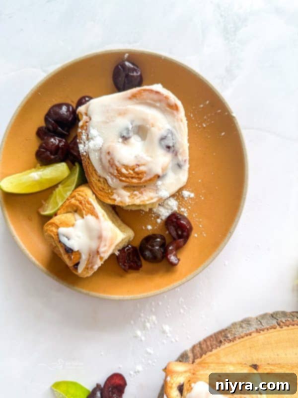 Zesty Cherry Limeade Sweet Rolls 3 Close-up of a Cherry Limeade Sweet Roll, showcasing its fluffy texture and a hint of the cherry filling peeking out.