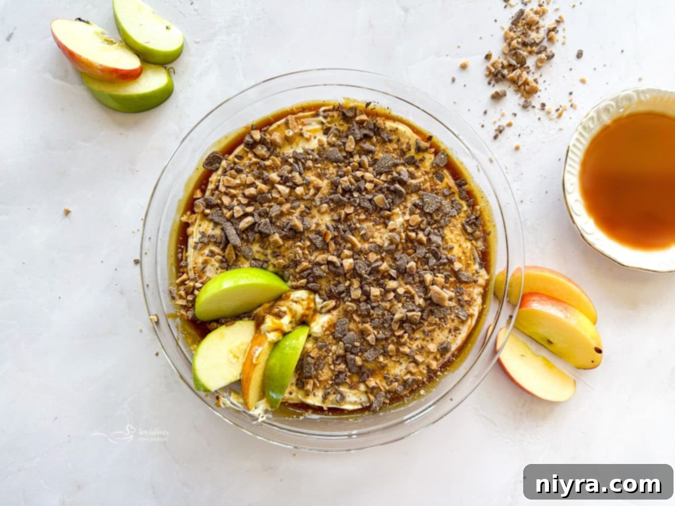 Overhead shot of Caramel Apple Dip in a serving dish with apple slices