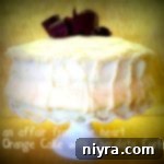 Side view of Orange Layer cake on a white cake platter with text 