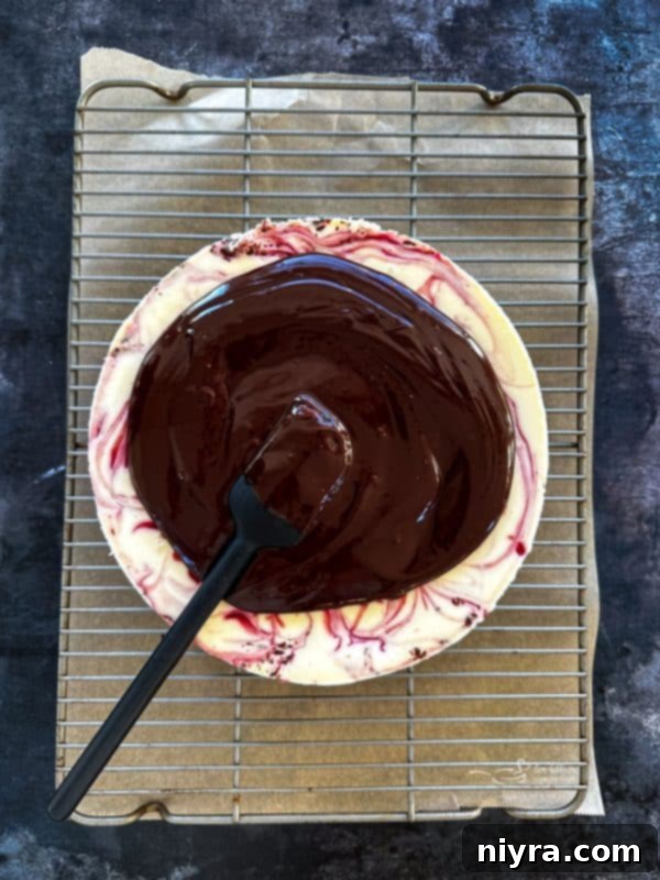 Decadent White Chocolate Raspberry Truffle Cheesecake 18 Smooth chocolate ganache being stirred in a saucepan