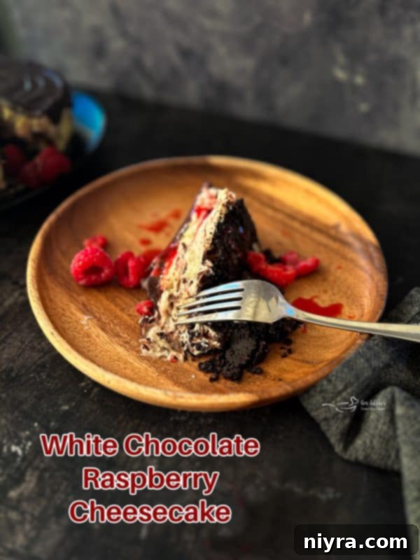 Decadent White Chocolate Raspberry Truffle Cheesecake 25 Glorious White Chocolate Raspberry Cheesecake, perfectly sliced and ready to serve