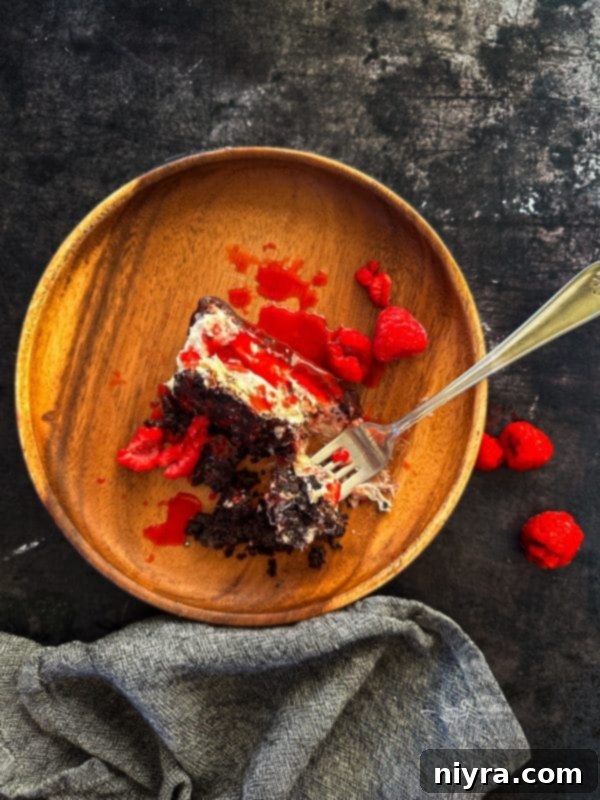 Decadent White Chocolate Raspberry Truffle Cheesecake 5 Perfect slice of White Chocolate Raspberry Cheesecake with visible layers