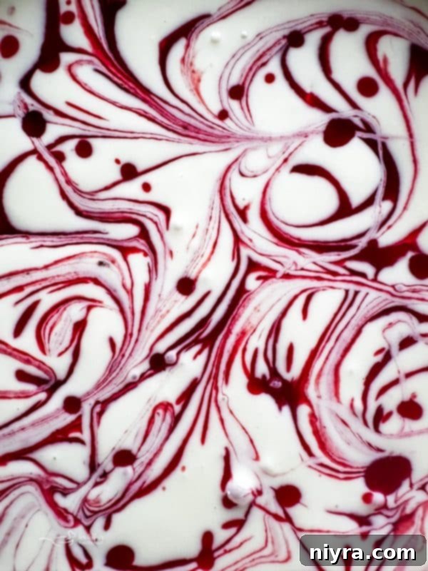 Decadent White Chocolate Raspberry Truffle Cheesecake 6 A whole White Chocolate Raspberry Cheesecake decorated with fresh raspberries and chocolate shavings