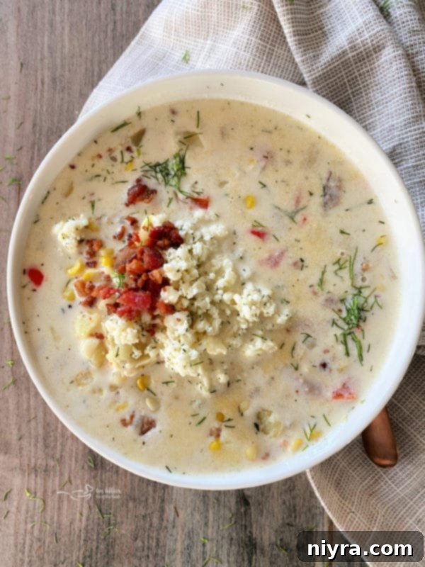 Creamy Cheesy Potato Corn Chowder, garnished with fresh dill and bacon