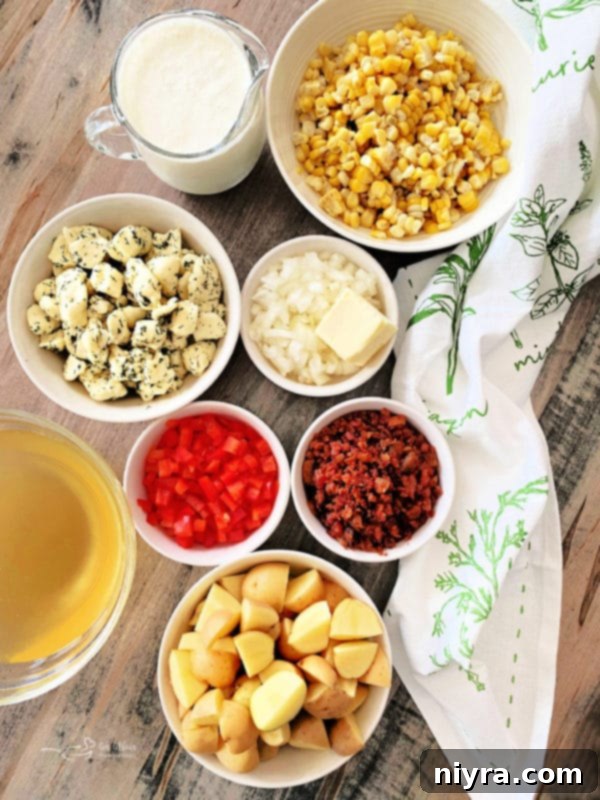 A large pot of Cheesy Potato Corn Chowder simmering on the stove