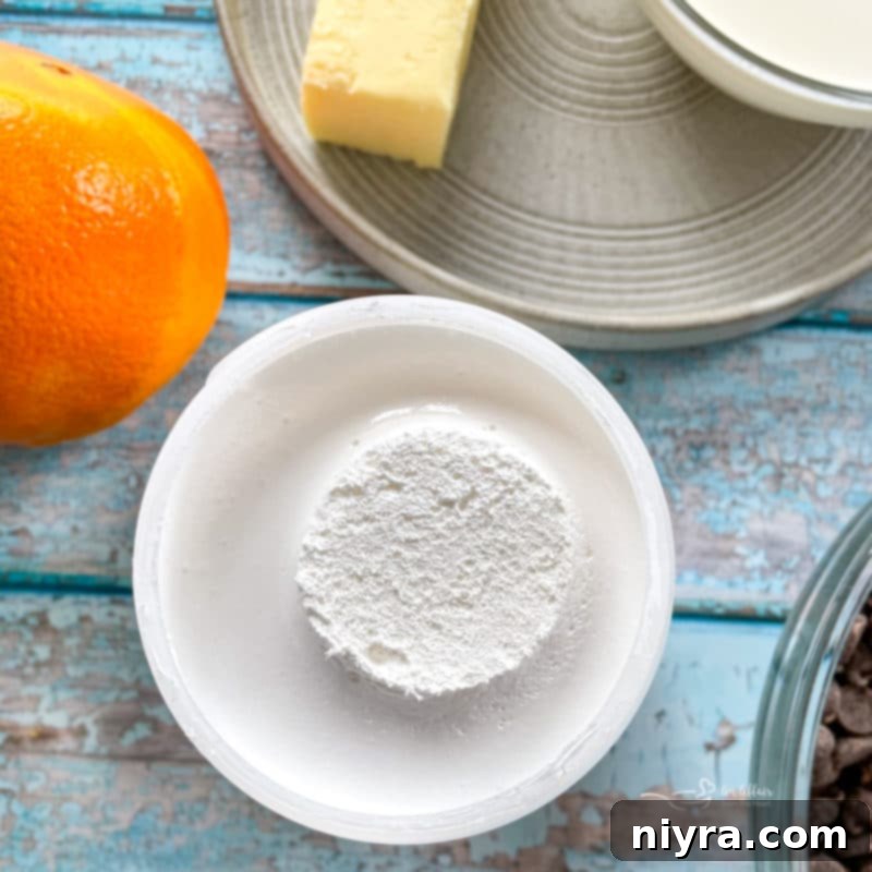 Close-up of fluffy white marshmallow cream, highlighting its light and airy texture, a key ingredient for ultra-creamy fudge.