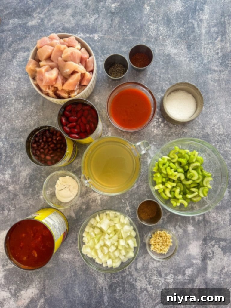 A serving spoon lifting a scoop of Buffalo Chicken Chili from a slow cooker, showcasing the texture and ingredients.