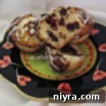 Decadent Raspberry Chocolate Chip Muffins 2 Chocolate Chip Raspberry Muffins on a multi-colored plate