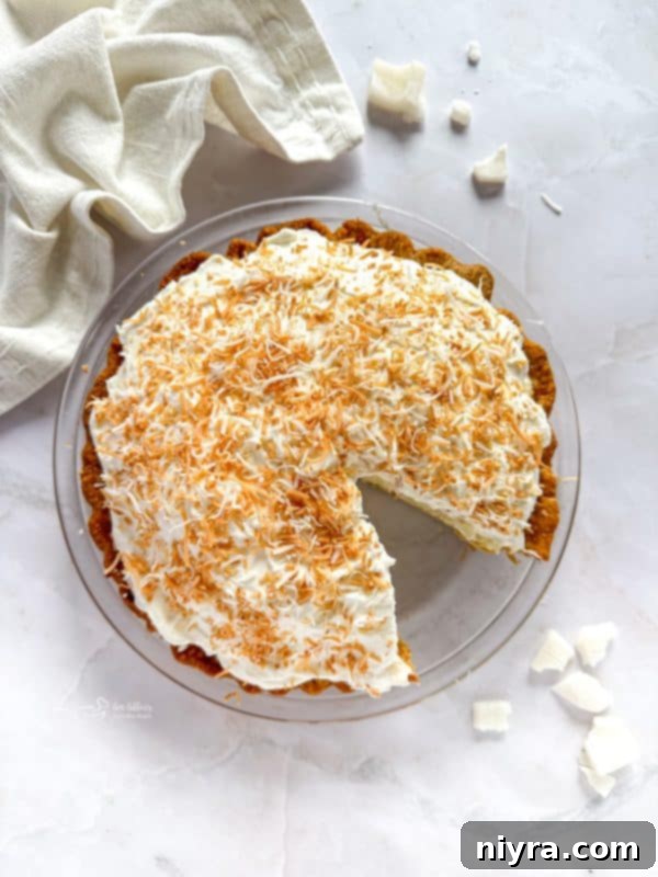 Tropical Coconut Dream Pie 3 Close-up of a slice of Coconut Cream Pie showing layers of custard and whipped cream