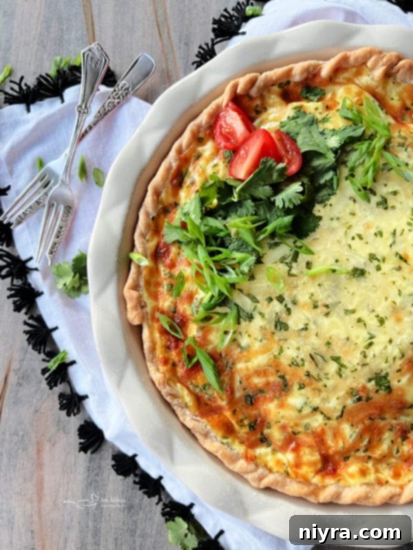 A slice of Green Chile Quiche with Sausage, viewed from the top, showing the golden crust and filling.