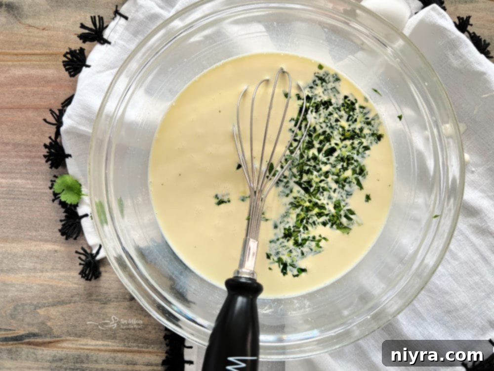 Whisked eggs and half & half in a bowl.