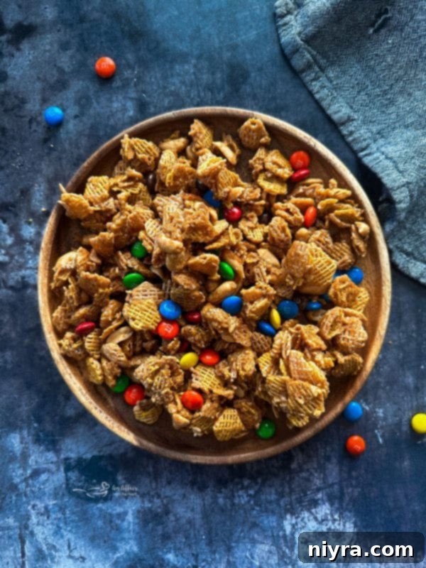 Irresistible Candy Coated Crispix Treat 2 A bowl of Candy Coated Crispix Mix with M&Ms and peanuts