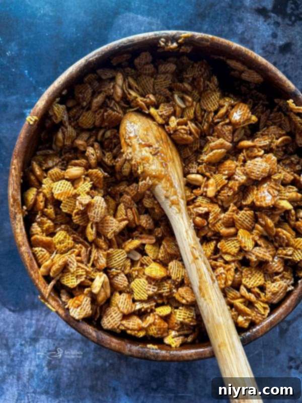 Irresistible Candy Coated Crispix Treat 12 Baking soda being stirred into the foamy caramel mixture