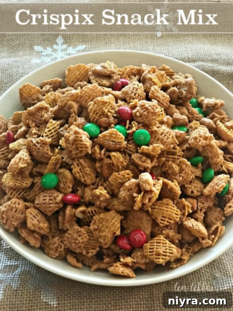 Irresistible Candy Coated Crispix Treat 18 Crispix Snack Mix in a white bowl with a spoon