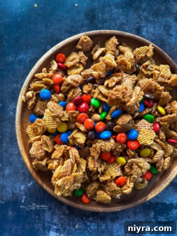 Irresistible Candy Coated Crispix Treat 4 Freshly baked Candy Coated Crispix Mix spread on a baking sheet