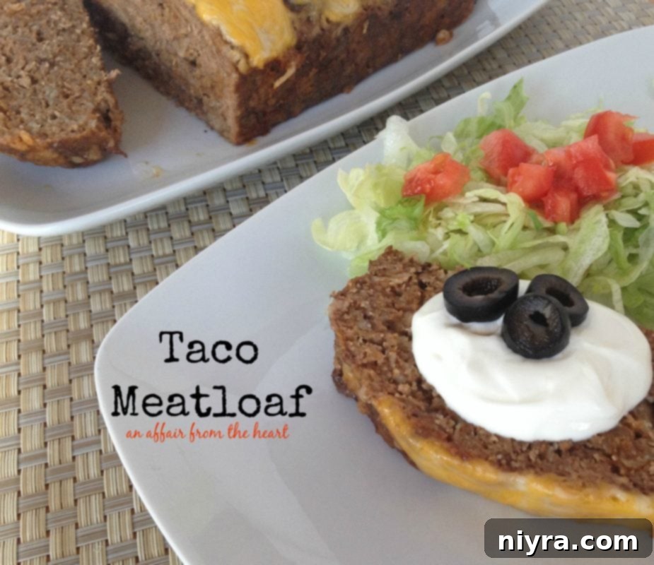 taco meatloaf with toppings and a side salad on a white plate