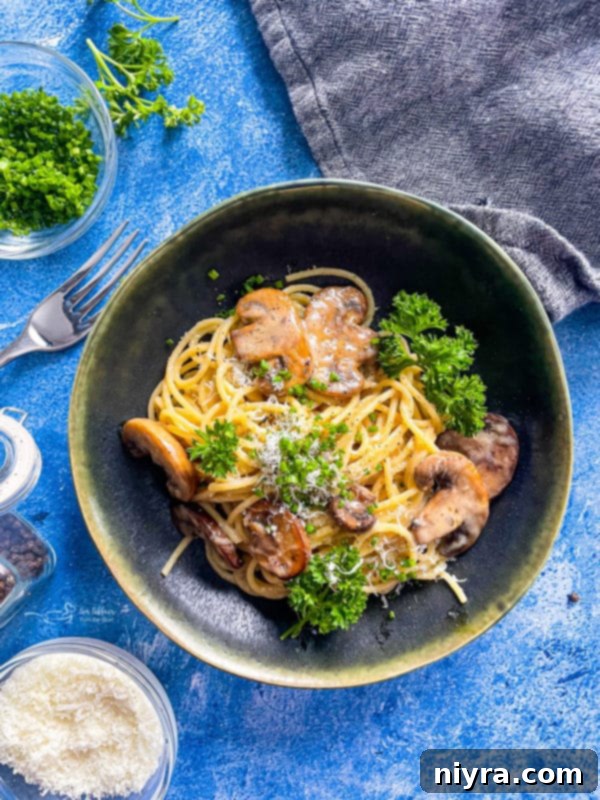 A beautifully plated bowl of Cacio e Pepe with mushrooms, garnished with fresh parsley, emphasizing its creamy texture and rich Italian flavors.