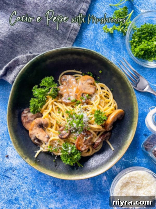 A top-down view of a single serving of Cacio e Pepe with mushrooms, garnished with fresh parsley, highlighting the creamy texture and rich Italian flavors.