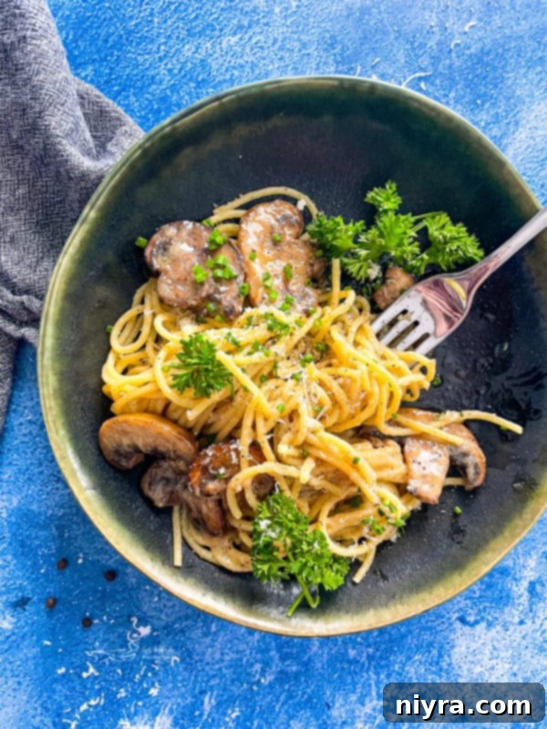 A bowl of creamy Cacio e Pepe pasta with mushrooms, perfect for two servings.